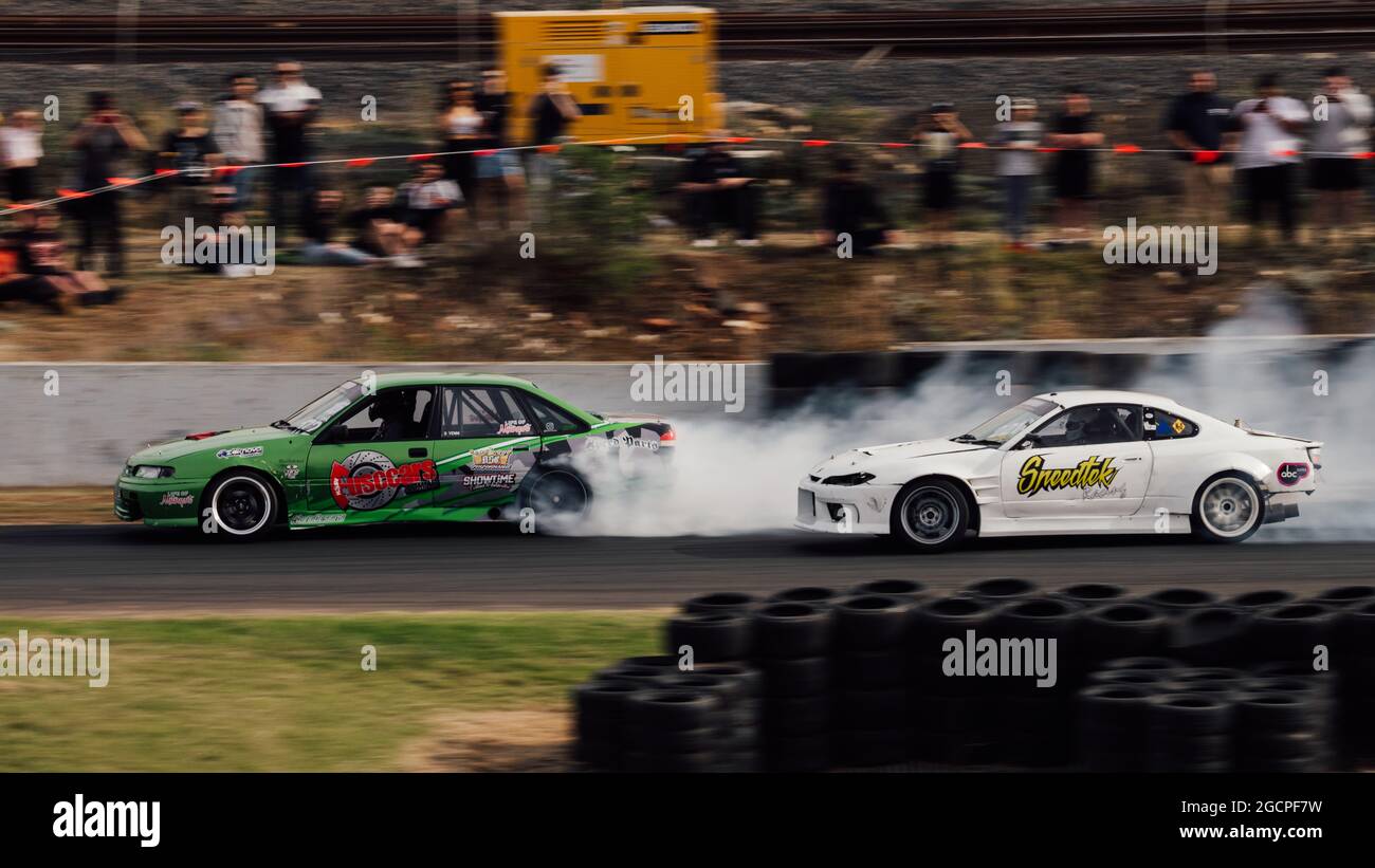 VicDrift Round 2: Ben Venni (left) takes drifts into the first corner in his LSA powered Holden Commodore leading from Aleksander Kantarovski (right) Stock Photo