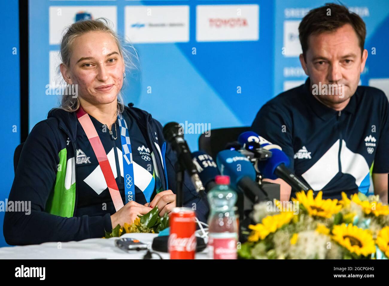 Zgornji Brnik, Slovenia. 09th Aug, 2021. Slovenian sport climber Janja  Garnbret and her coach Roman Krajnik attend a press conference upon their  arrival at Ljubljana Airport from Tokyo Olympics. On August 6,