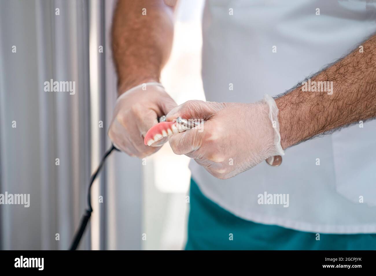 Grinding of the denture. Close-up Stock Photo