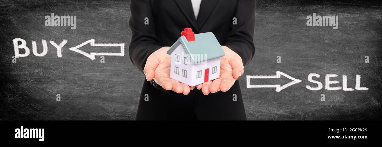 Real estate broker showing miniature house for buy and sell home housing market concept. Panoramic banner on black blackboard woman holding home with Stock Photo