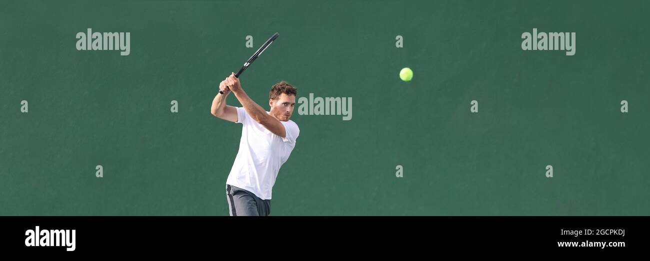 Tennis player man playing hitting ball with racket on green horizontal banner background. Sports athlete training grip technique on outdoor court. Stock Photo