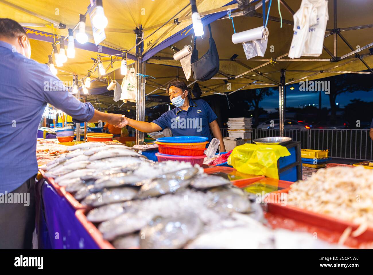 Street food night market at Putrajaya, near Kuala Lumpur. Salesman with