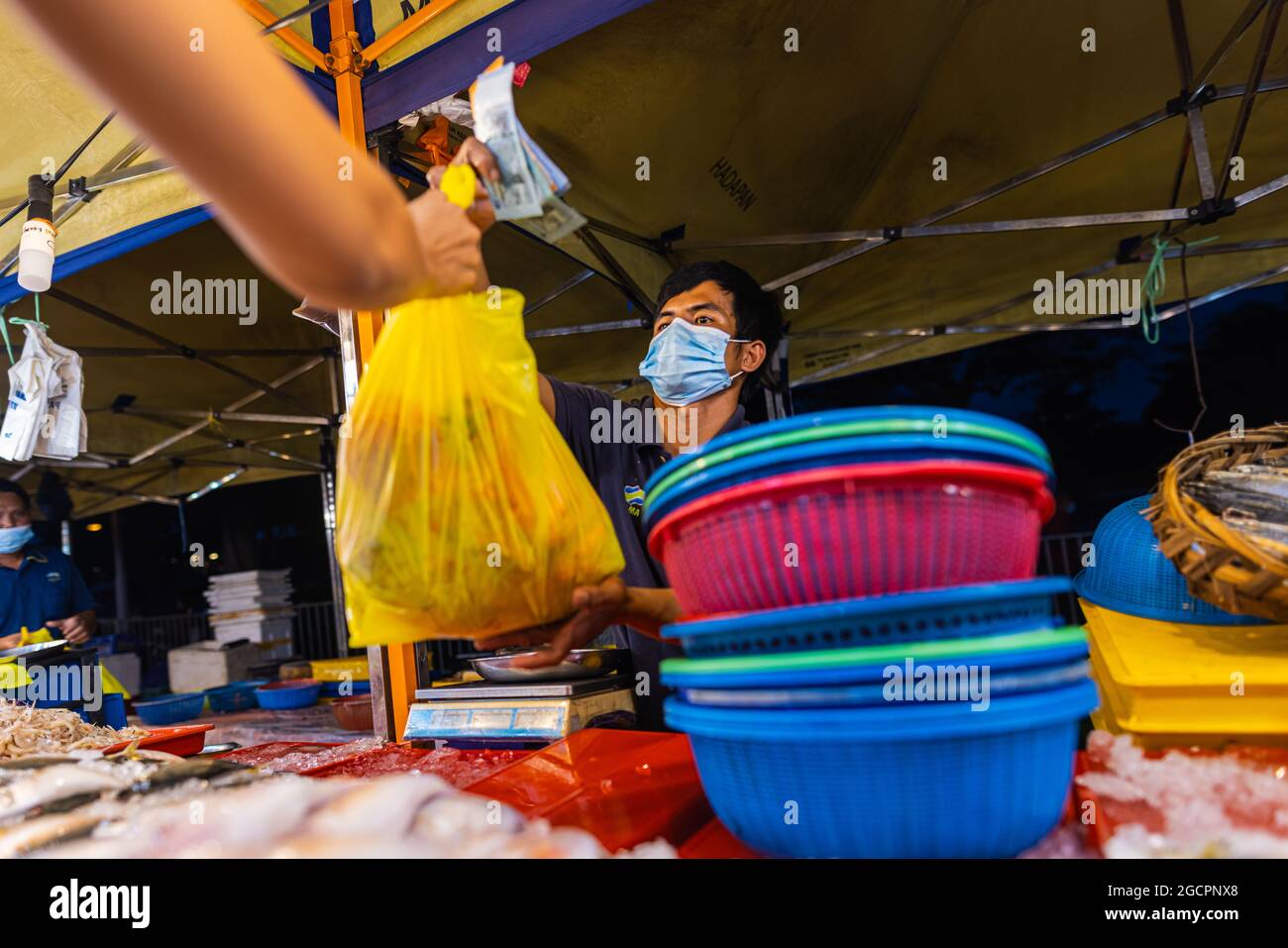 Street food night market at Putrajaya, near Kuala Lumpur. Salesman with
