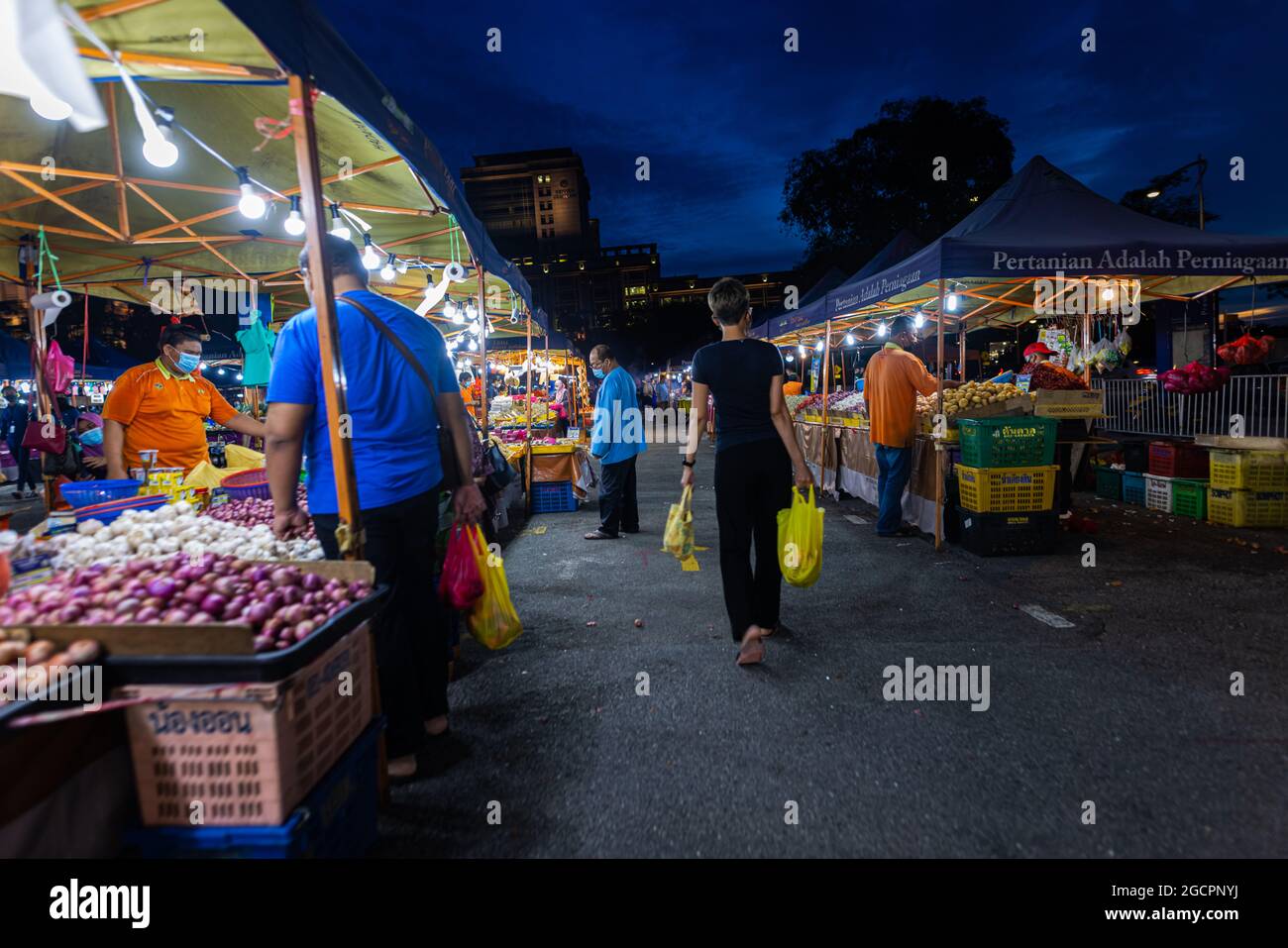 Street food night market at Putrajaya, near Kuala Lumpur. Young woman