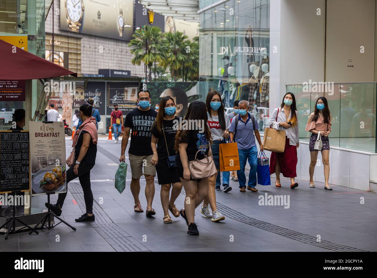 Kuala Lumpur, Malaysia - October 04, 2020: Street scene in Corona times. People with Face mask passing by. Masks are compulsory in crowded areas in Ma Stock Photo