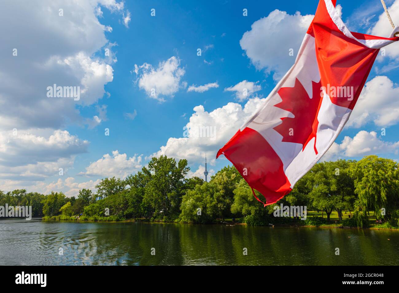 Canadian flag on a cruise boat at the islands around the city of Toronto. The red and white flag of Canada with the maple  leaf in the center. The CN Stock Photo