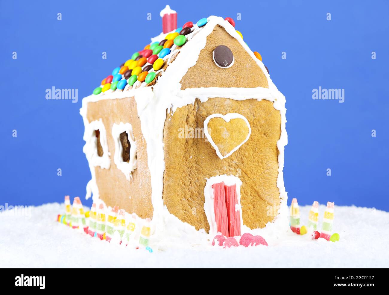Gingerbread house on blue background Stock Photo - Alamy