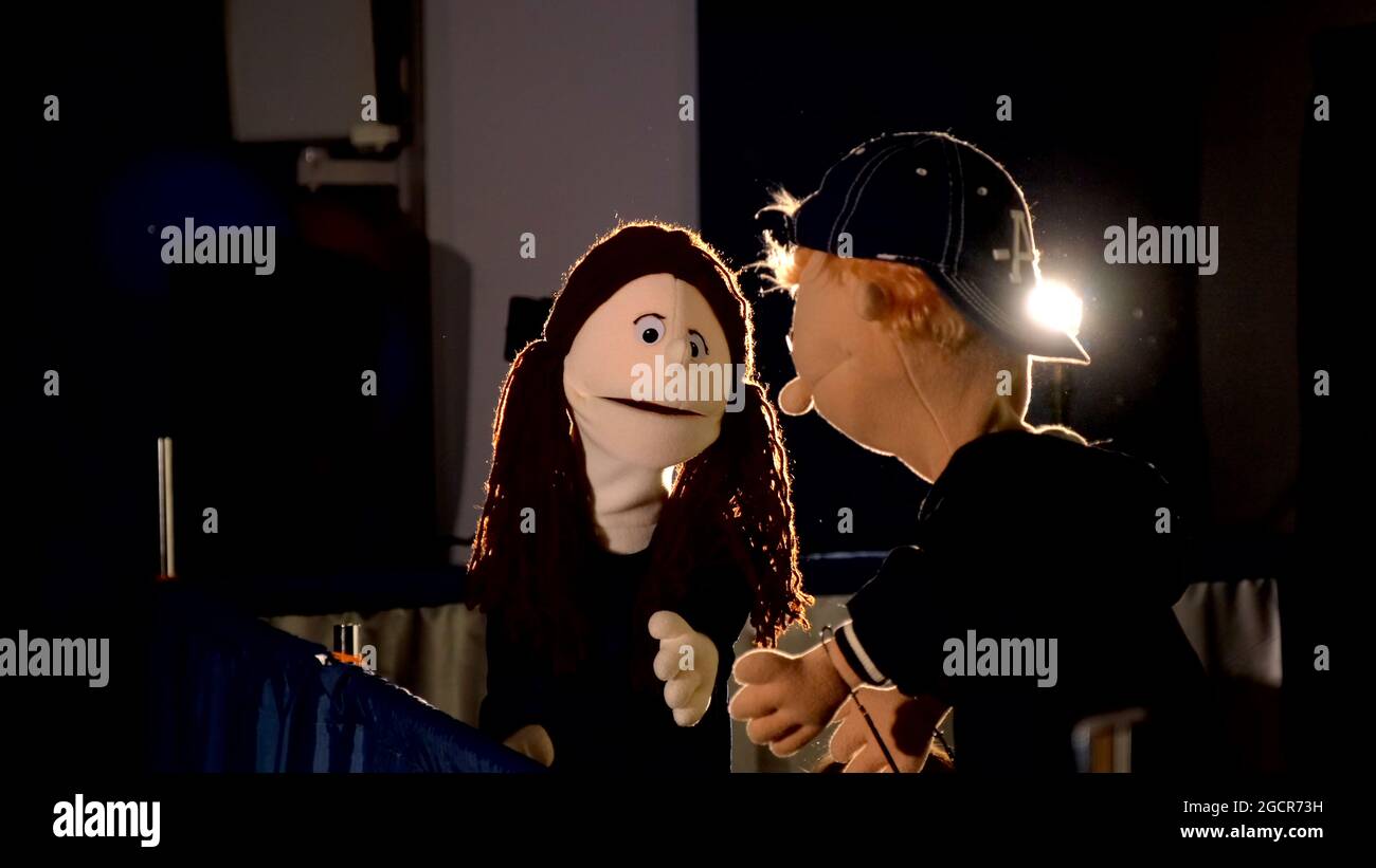 Puppet girl speaking with puppet boy during the performance. In the