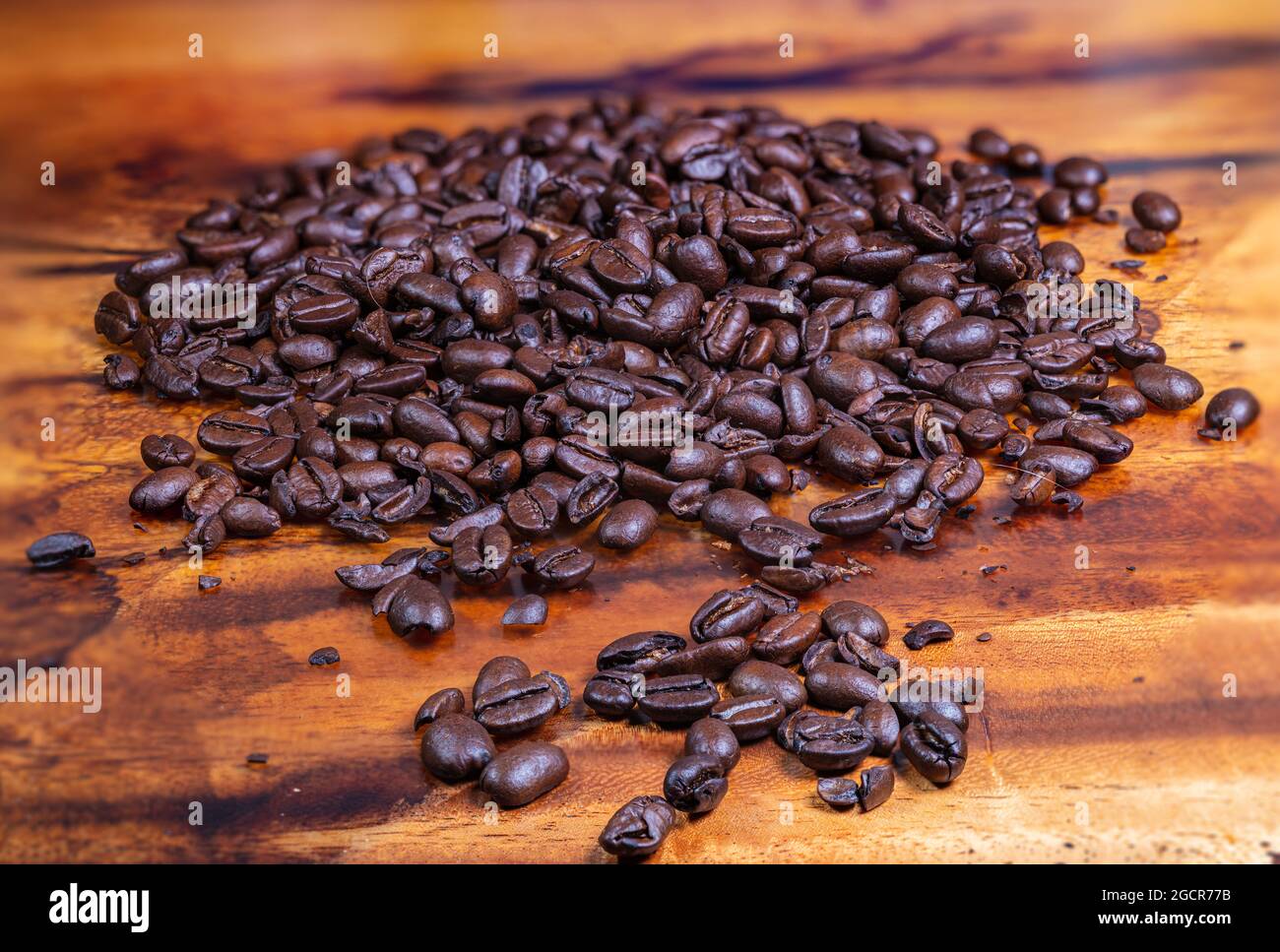 Macro photography of a heap fresh roasted coffee beans on a wooden ...