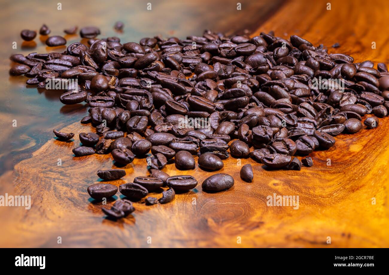 Macro photography of a heap fresh roasted coffee beans on a wooden ...