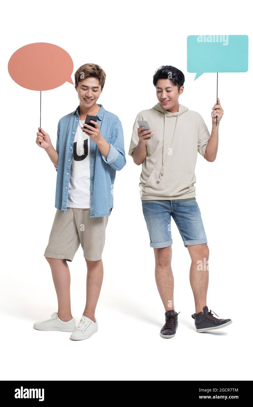 Happy young friends using smartphone Stock Photo