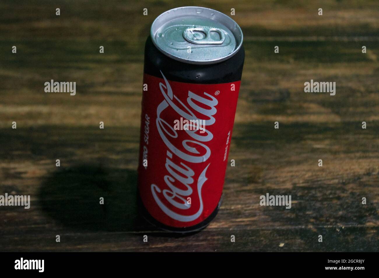 Lampung, Indonesia - august 4, 2021 : Cold coca cola can drink on a brown wooden background. Stock Photo