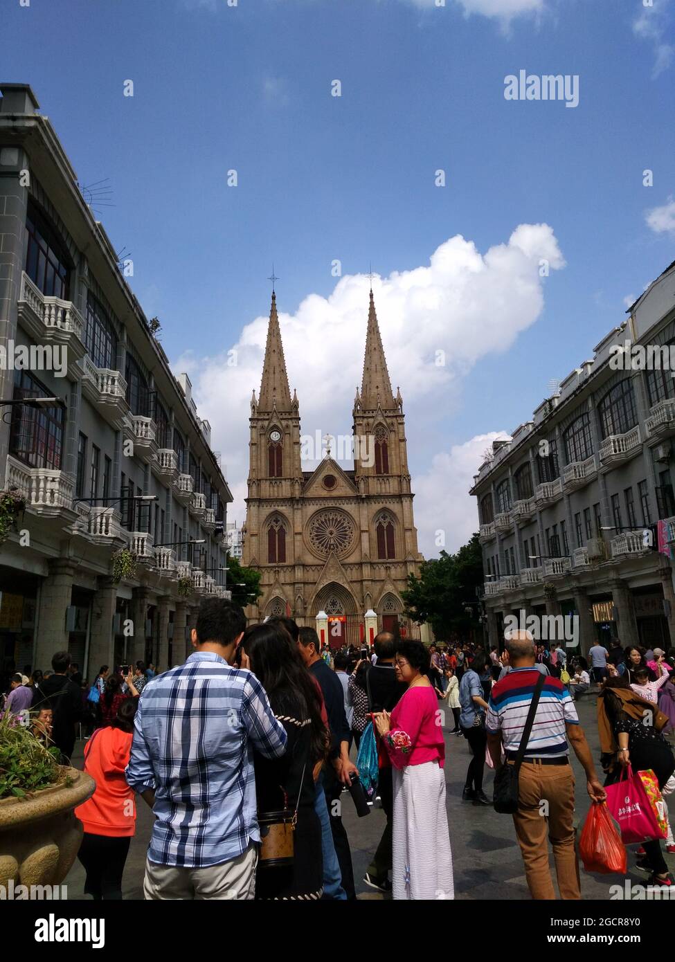 beautiful Sacred Heart Cathedral in Guangzhou packed with tourists angelic cross steeples Stock Photo