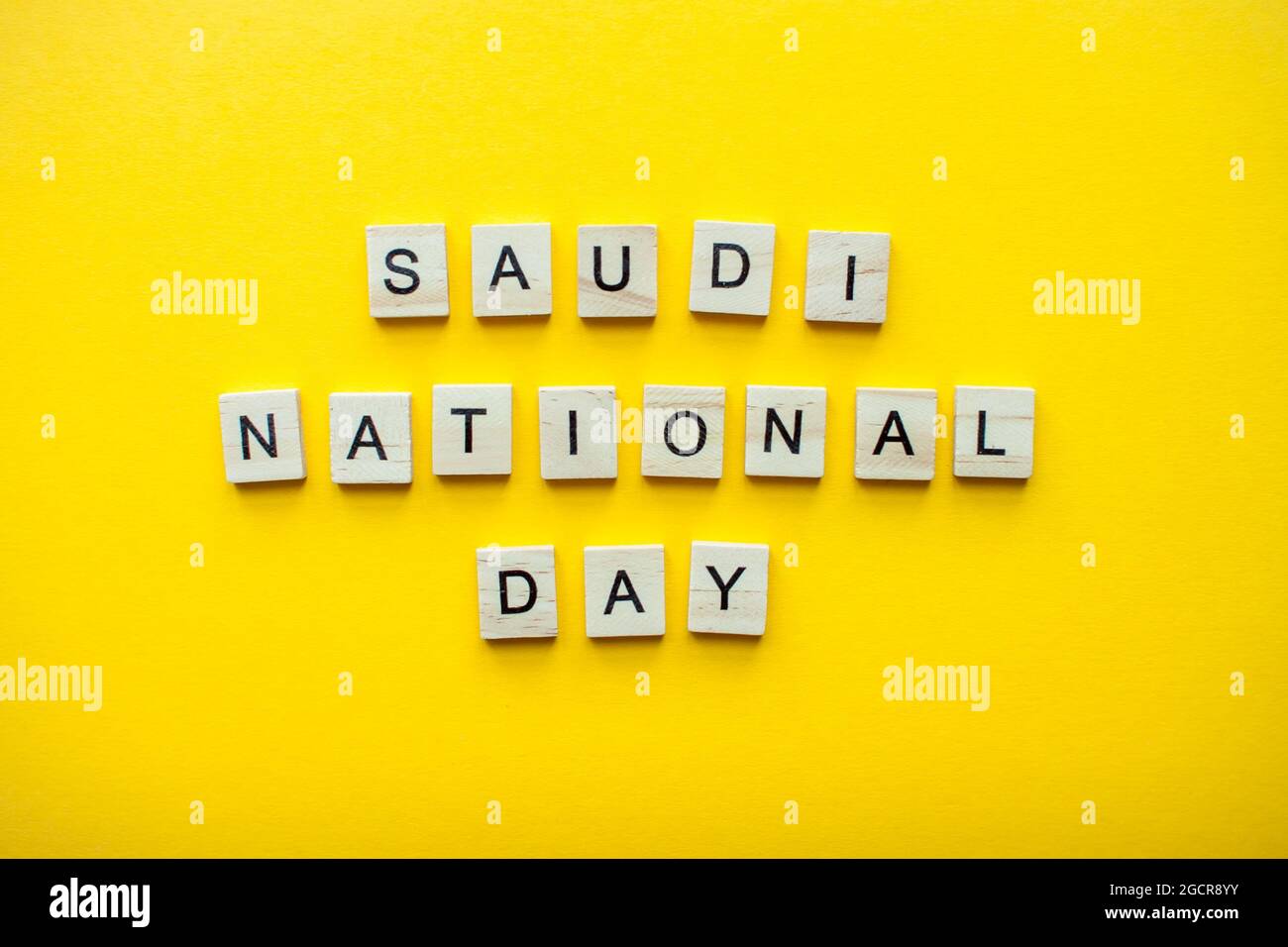 The inscription saudi national day from wooden blocks on a bright yellow background Stock Photo