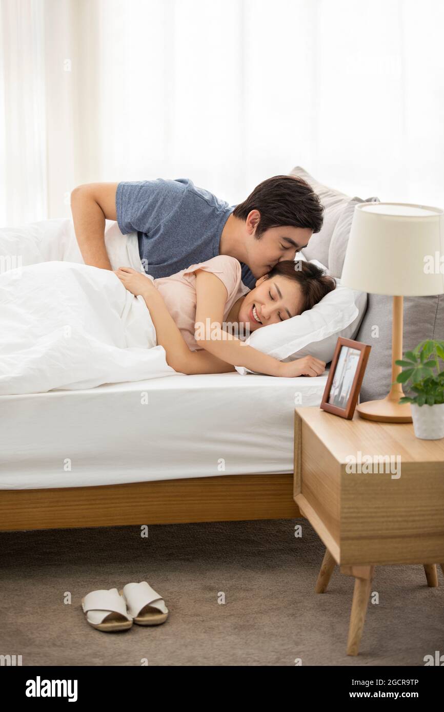 Young couple sleeping in bed Stock Photo