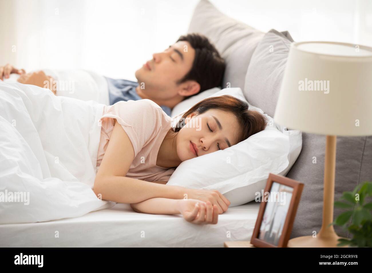 Young couple sleeping in bed Stock Photo Alamy