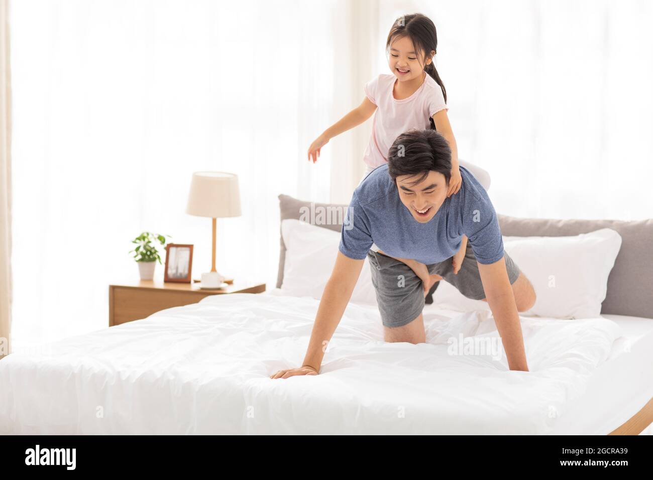 Happy father and daughter having fun in bedroom Stock Photo - Alamy