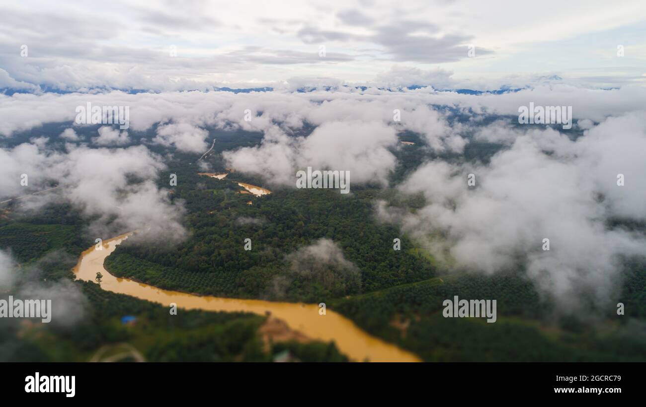 Aerial view over the landscape at the rock of Gua Charas, Pahang, Malaysia, near the east coast of Malaysia and the town of Kuantan. Over the clouds a Stock Photo