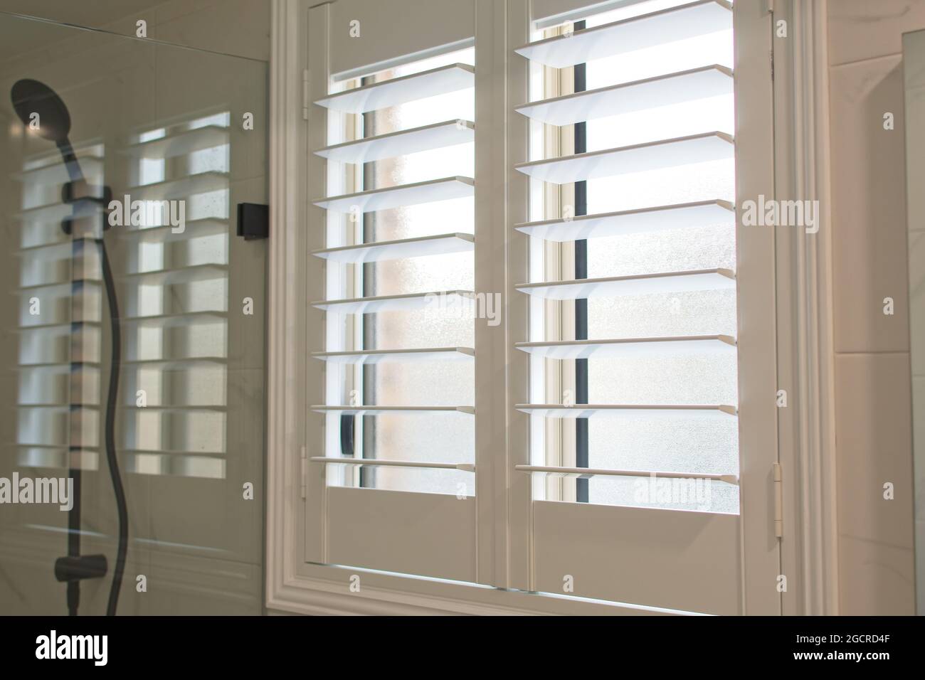Luxury white plantation shutters in bathroom Stock Photo Alamy