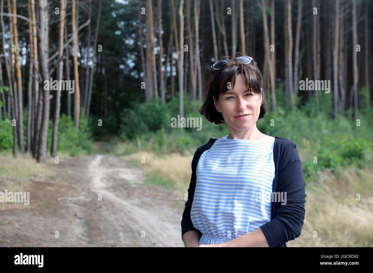Beautiful young woman on a walk in the summer forest. Nature Stock ...