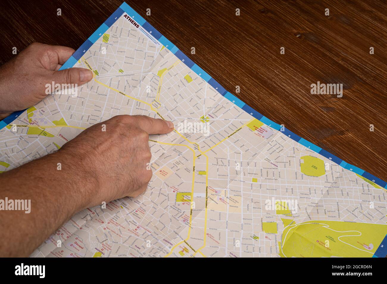 Udine, Italy. August 7 2021. A man looking at the map of the city of Athens Stock Photo