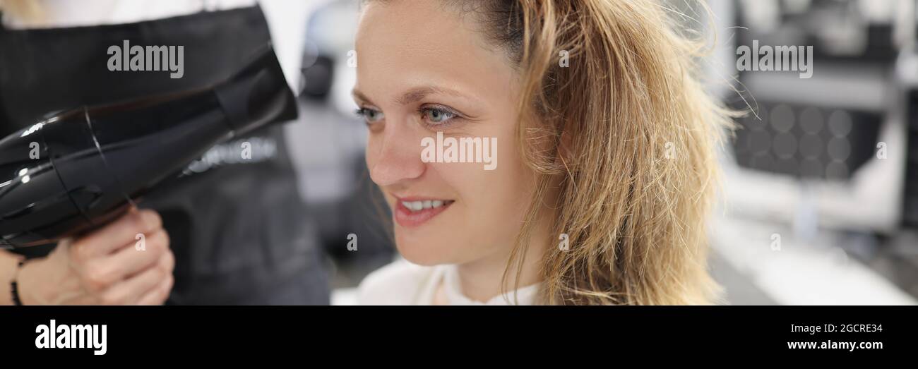 Stylist drying woman hair hi-res stock photography and images - Alamy