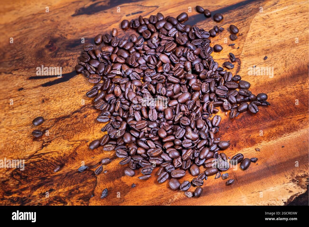 https://c8.alamy.com/comp/2GCREXW/macro-photography-top-view-of-a-heap-fresh-roasted-coffee-beans-on-a-wooden-background-high-resolution-detailed-close-up-of-brown-roasted-coffee-bean-2GCREXW.jpg