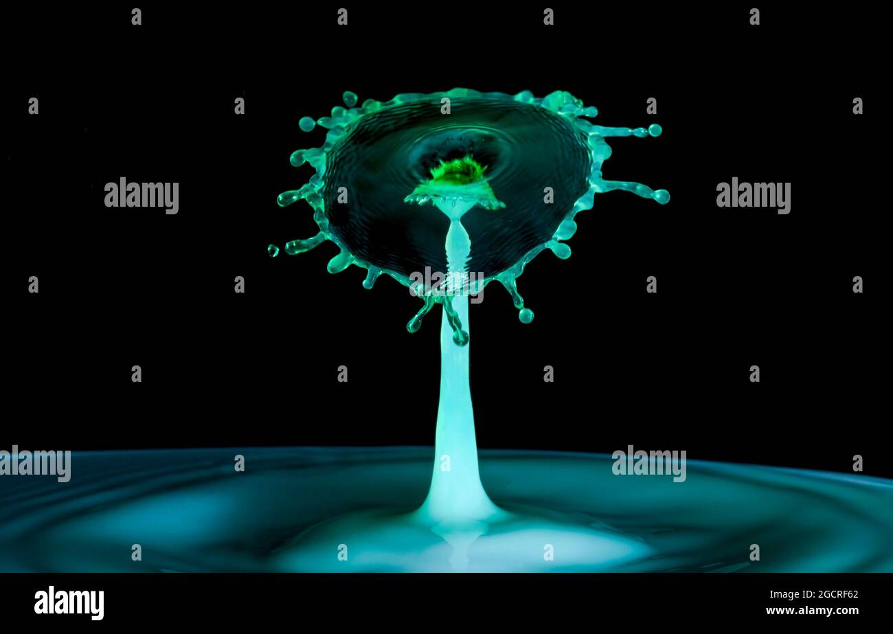Close-up photograph of two water droplets colliding making an unusual ...