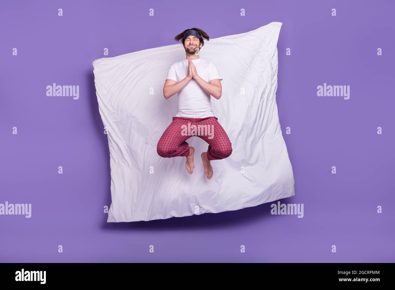 Full body portrait of handsome guy closed eyes hands palms together