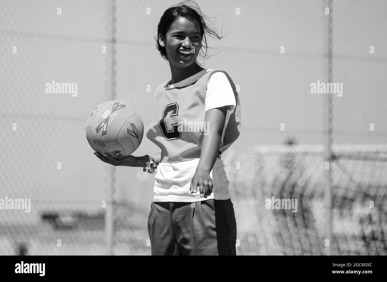 CAPE TOWN, SOUTH AFRICA - Jan 05, 2021: A grayscale of a young female athlete playing Netball at school in Cape Town, South Africa Stock Photo