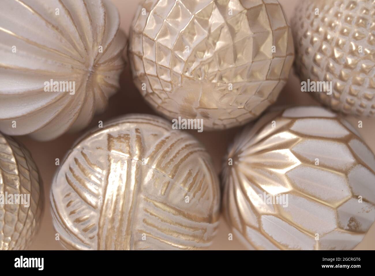 beige christmas decorative balls.Beige textured background. Festive christmas background in beige sand golden tones. Stock Photo