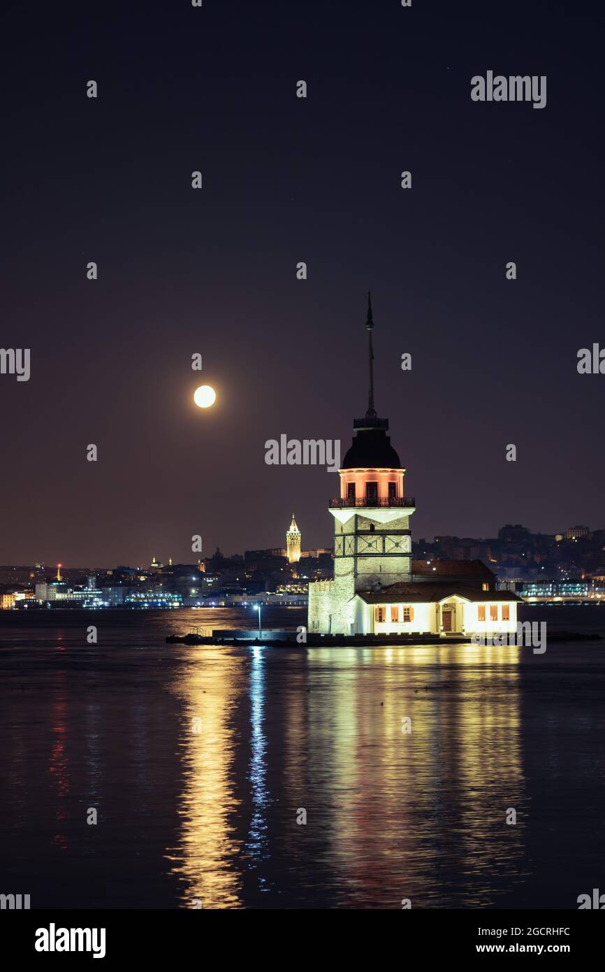 Maiden's Tower and Galata Tower at night with full moon. Kiz Kulesi and ...