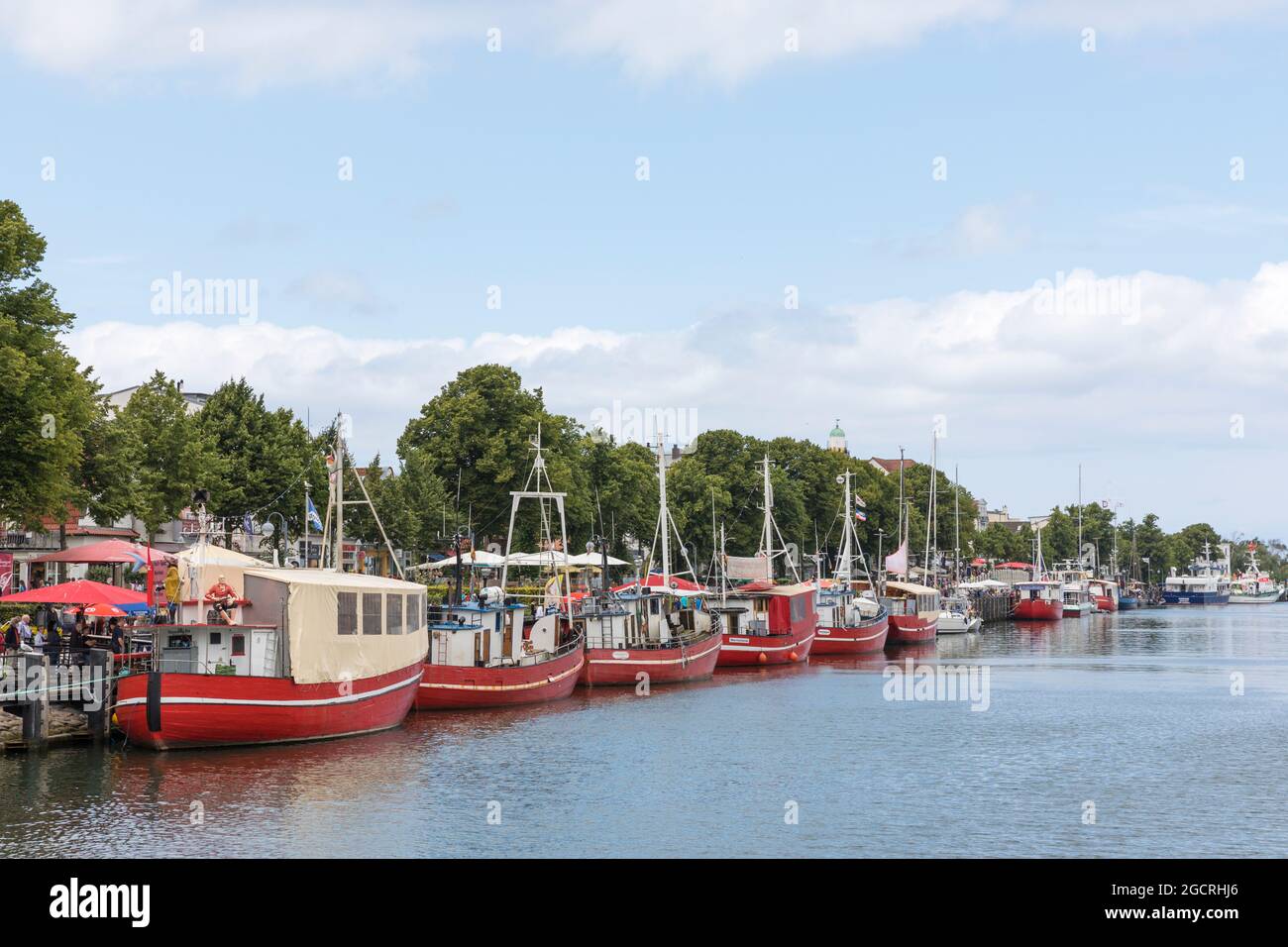 Old fishing boats used by fish merchants at the harbor of Warnemünde called Alter Strom Stock Photo