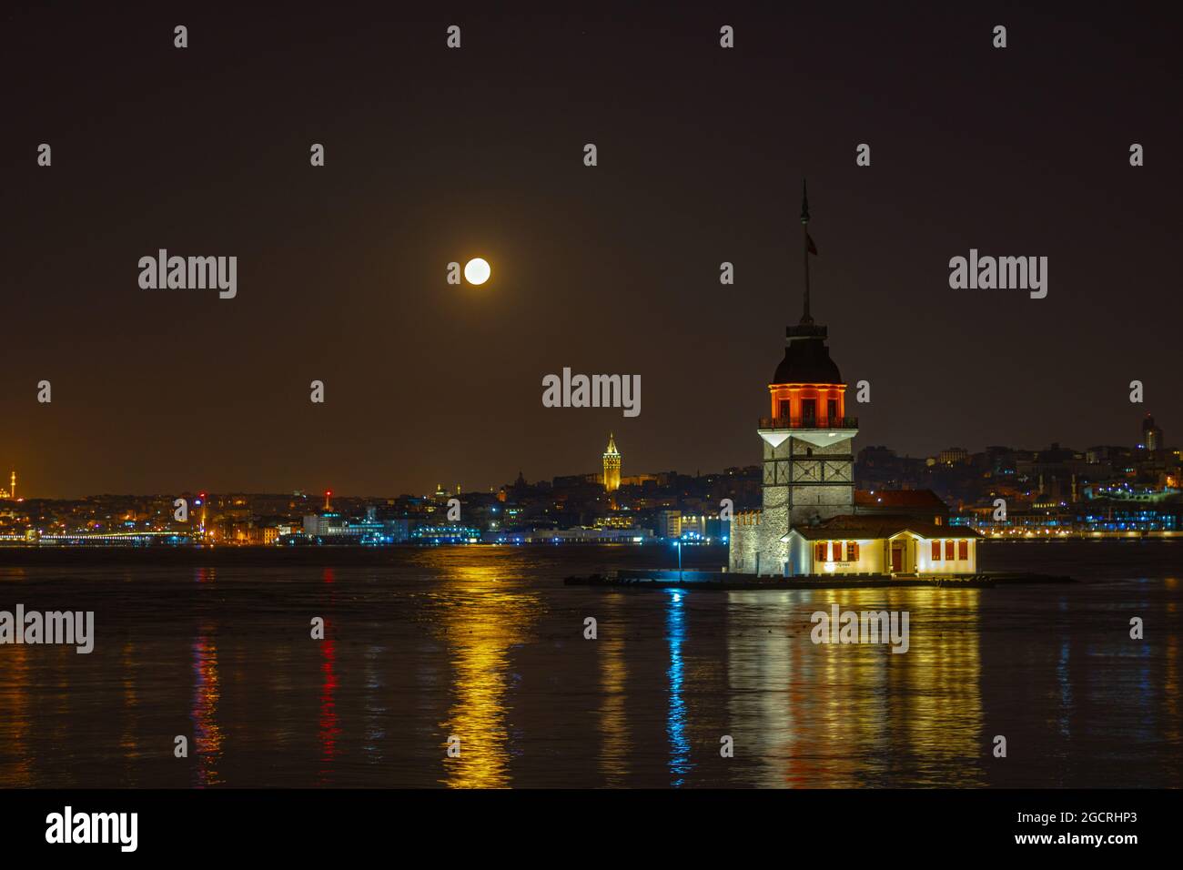 Maiden's Tower and Galata Tower at night with full moon. Kiz Kulesi and ...