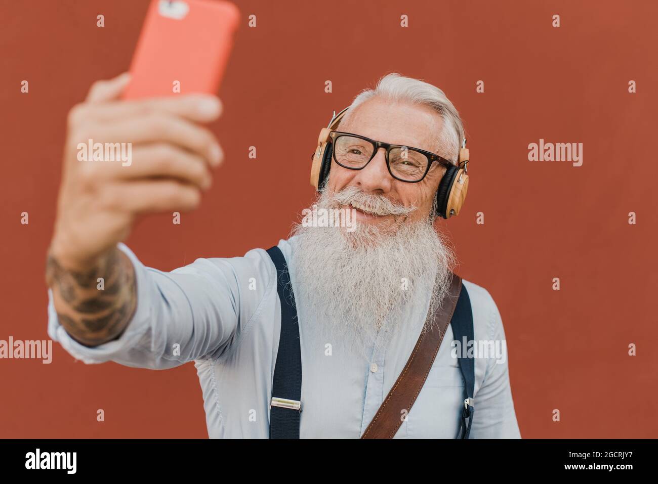 senior man using smartphone for fun Stock Photo