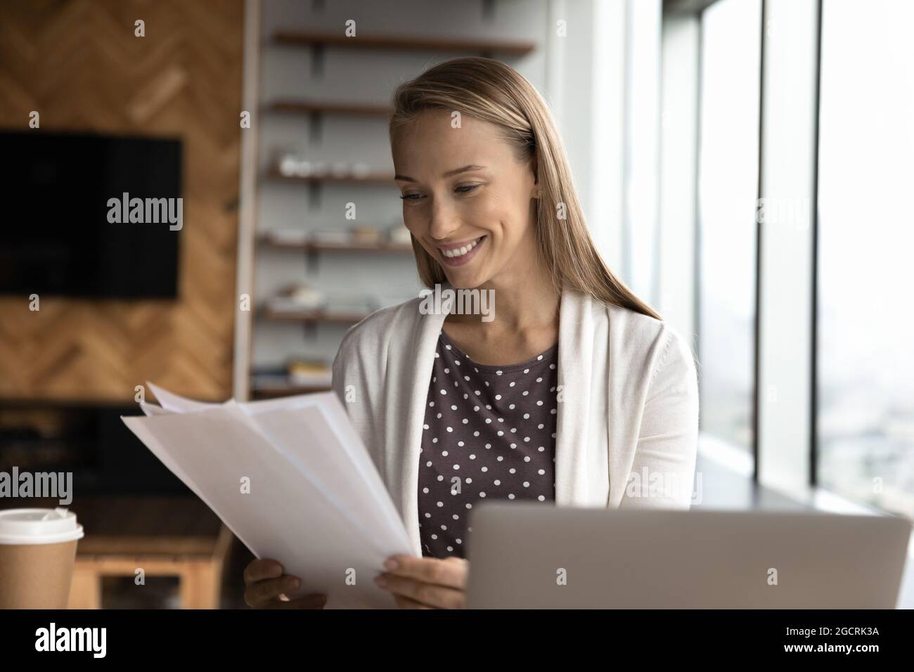 Happy business woman, office employee, assistant reviewing papers Stock Photo