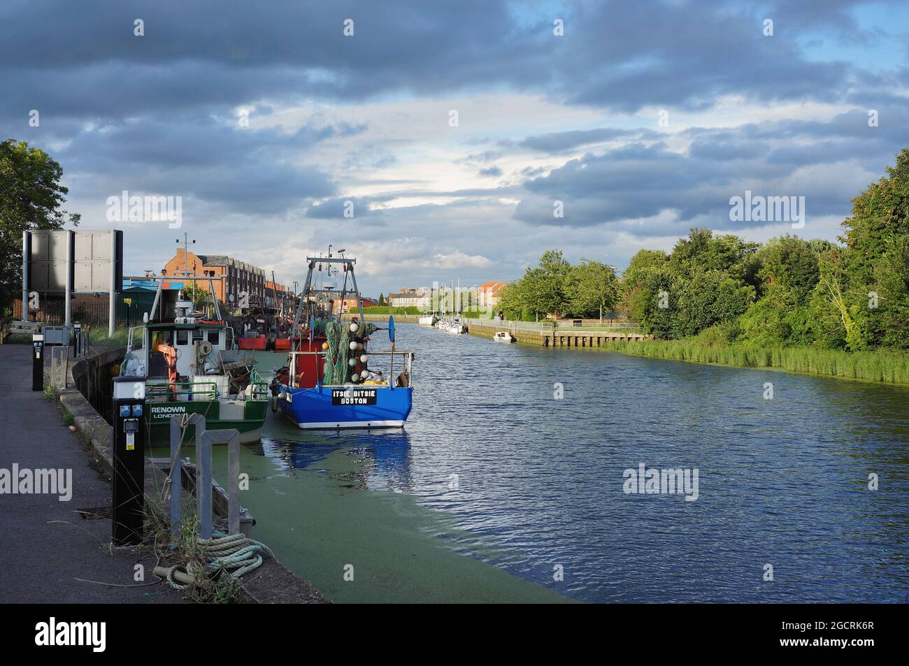 The river Haven (witham) with its moored fishing boats and tree lined riverbank from the High St. Stock Photo