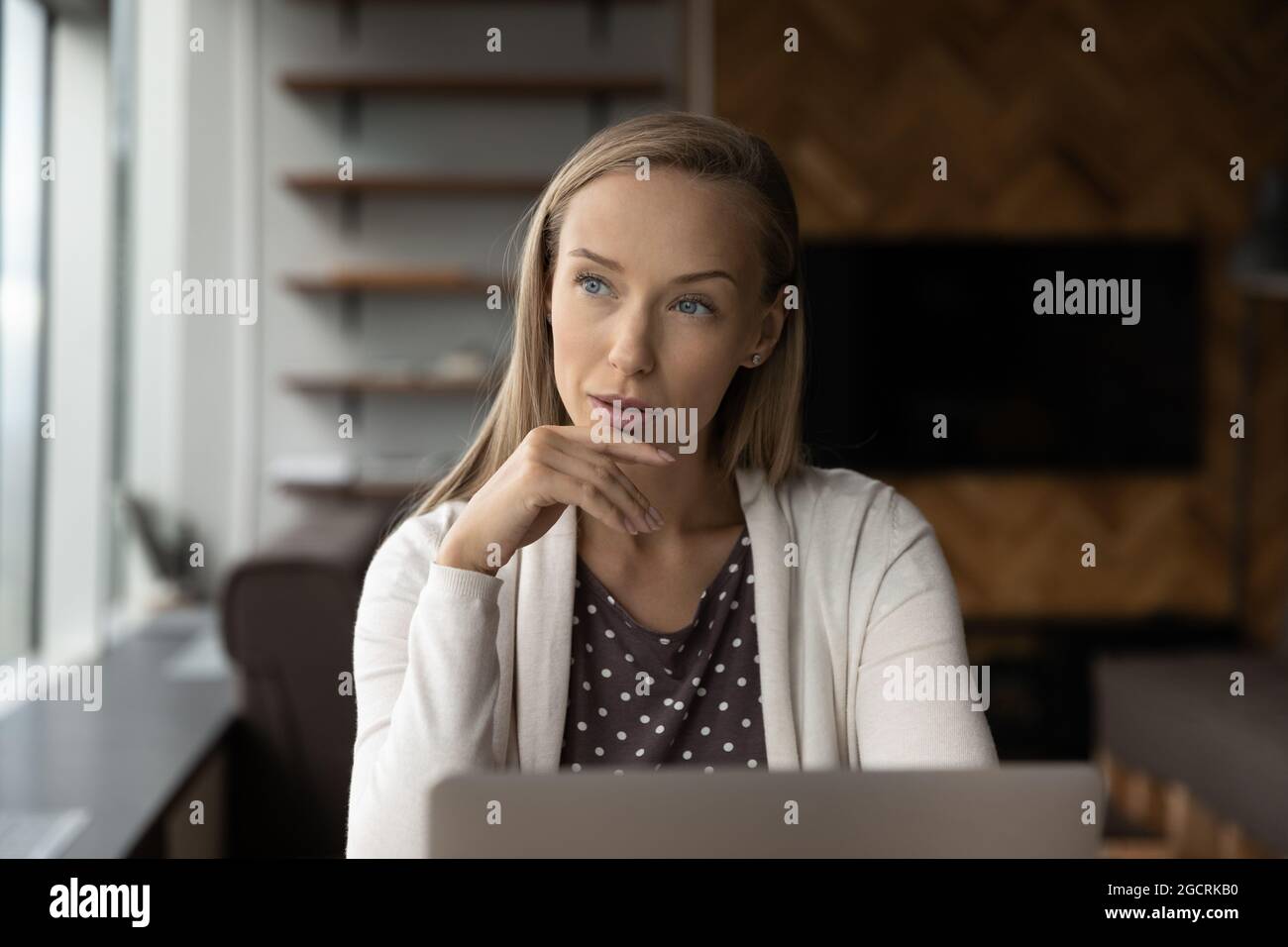 Serious thoughtful office employee, business woman, leader making decision Stock Photo