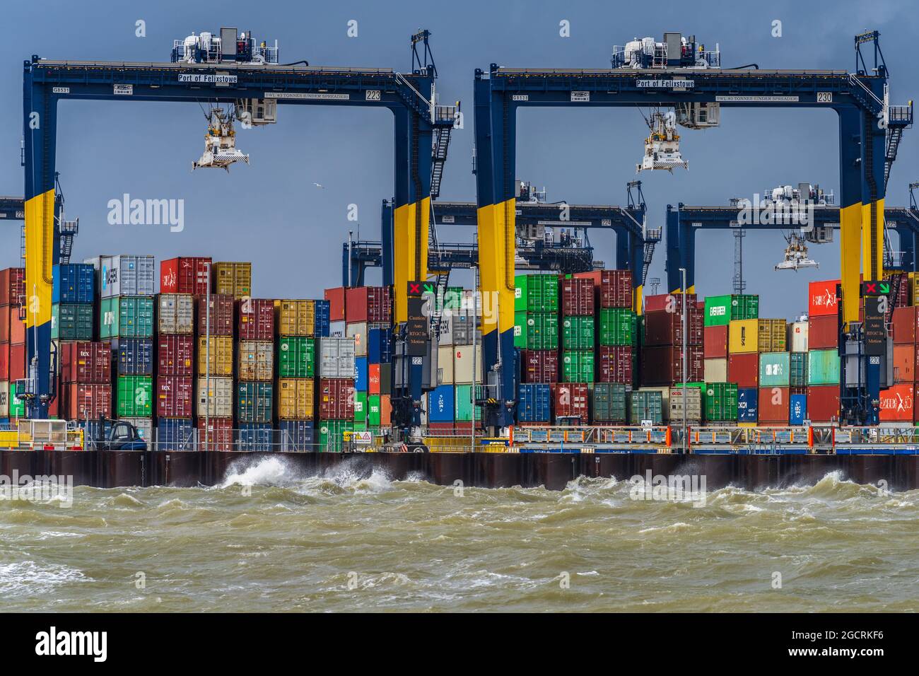 Global Supply Chains - Containers on the dockside at the Port of Felixstowe UK during stormy weather. Global Supply Chain Congestion. Stock Photo
