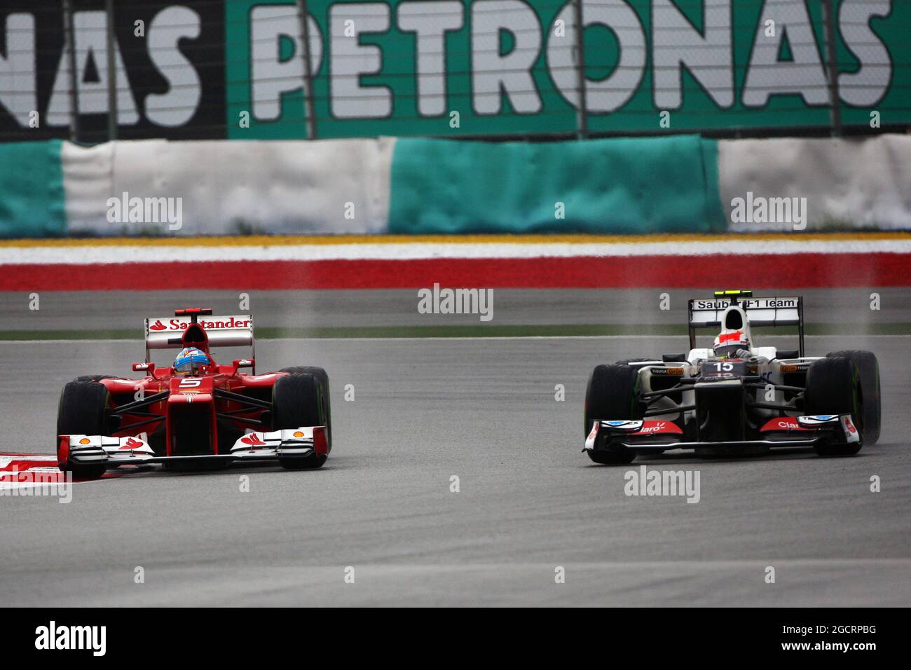 (L to R): Race winner Fernando Alonso (ESP) Ferrari F2012 and Sergio Perez (MEX) Sauber C31 battle for position. 25.03.2012. Formula 1 World Championship, Rd 2, Malaysian Grand Prix, Sepang, Malaysia, Sunday Race Stock Photo