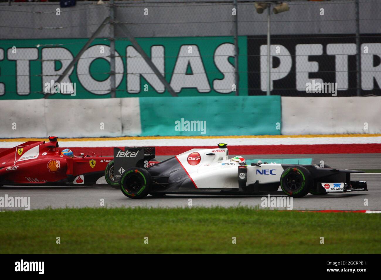 (L to R): Race winner Fernando Alonso (ESP) Ferrari F2012 and Sergio Perez (MEX) Sauber C31 battle for position. 25.03.2012. Formula 1 World Championship, Rd 2, Malaysian Grand Prix, Sepang, Malaysia, Sunday Race - www.xpbimages.com, EMail: requests@xpbimages.com - copy of publication required for printed pictures. Every used picture is fee-liable. Â© Copyright: Moy / XPB Images Stock Photo