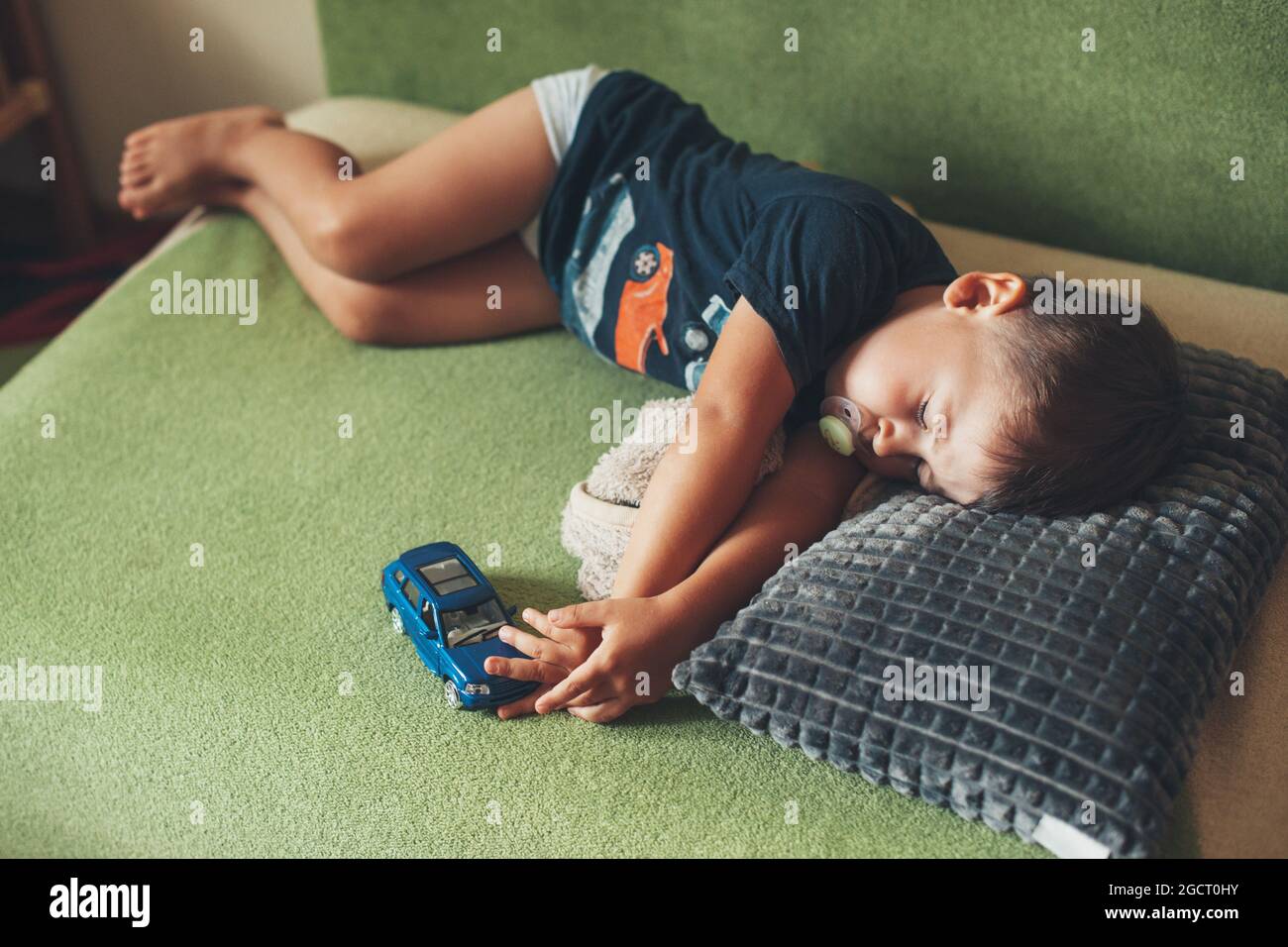 Kid sleep with car toy. Summer napping for children. Relaxational concept Stock Photo