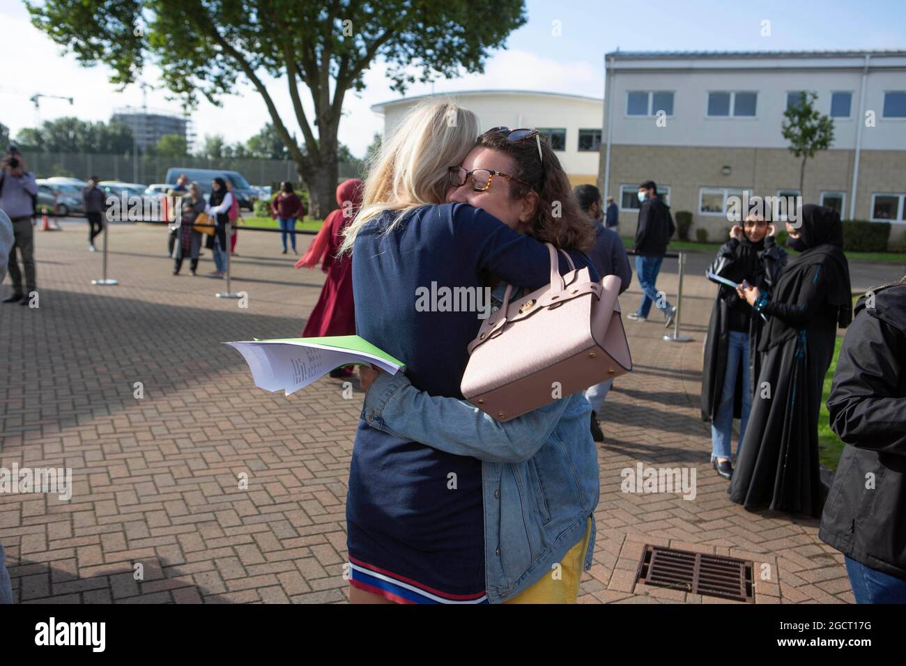 Lois Ryott (left) and Maya Hill at Brampton Manor Academy in Lndon celebrate with each other