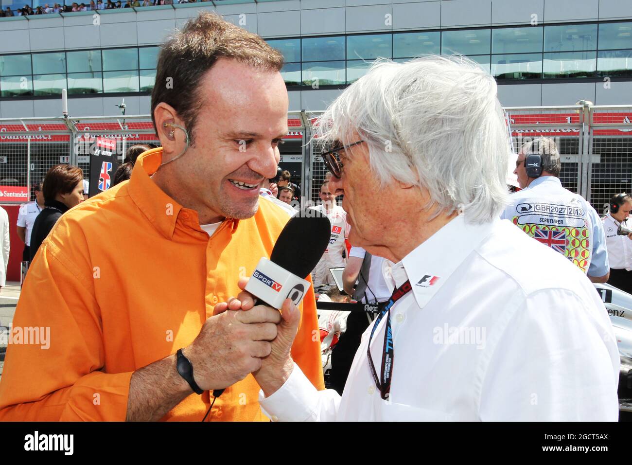 (L to R): Rubens Barrichello (BRA) with Bernie Ecclestone (GBR) CEO Formula One Group (FOM) on the grid. British Grand Prix, Sunday 30th June 2013. Silverstone, England. Stock Photo
