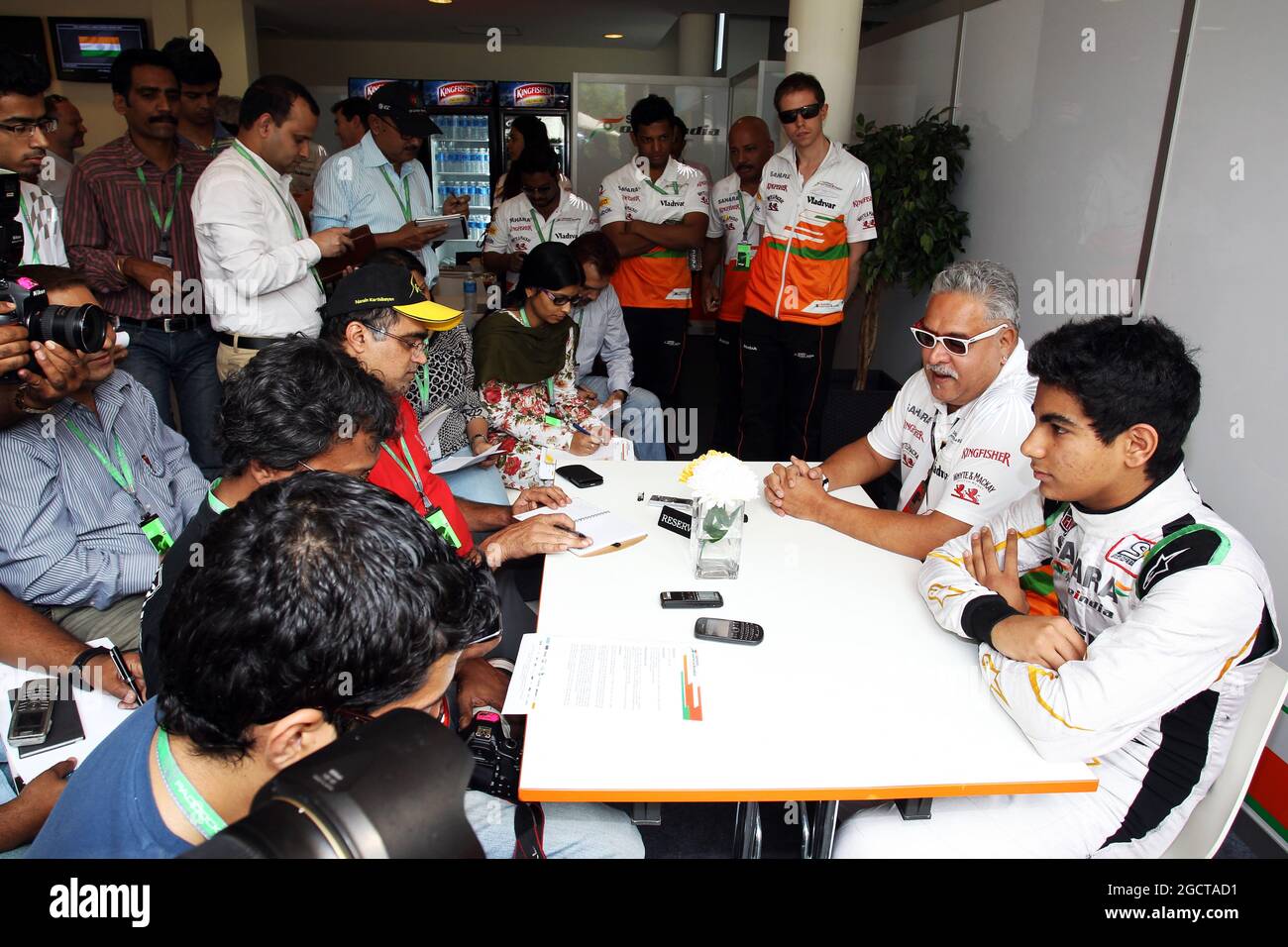 (L to R): Dr. Vijay Mallya (IND) Sahara Force India F1 Team Owner and Jehan Daruvala (IND) Sahara Force India Academy Driver, winner of the British KF3 Karting Championship, with the media. Indian Grand Prix, Saturday 26th October 2013. Greater Noida, New Delhi, India. Stock Photo