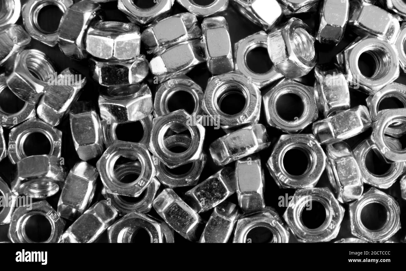 Metal nuts in a row background. Chromed screw nut texture. Steel nuts