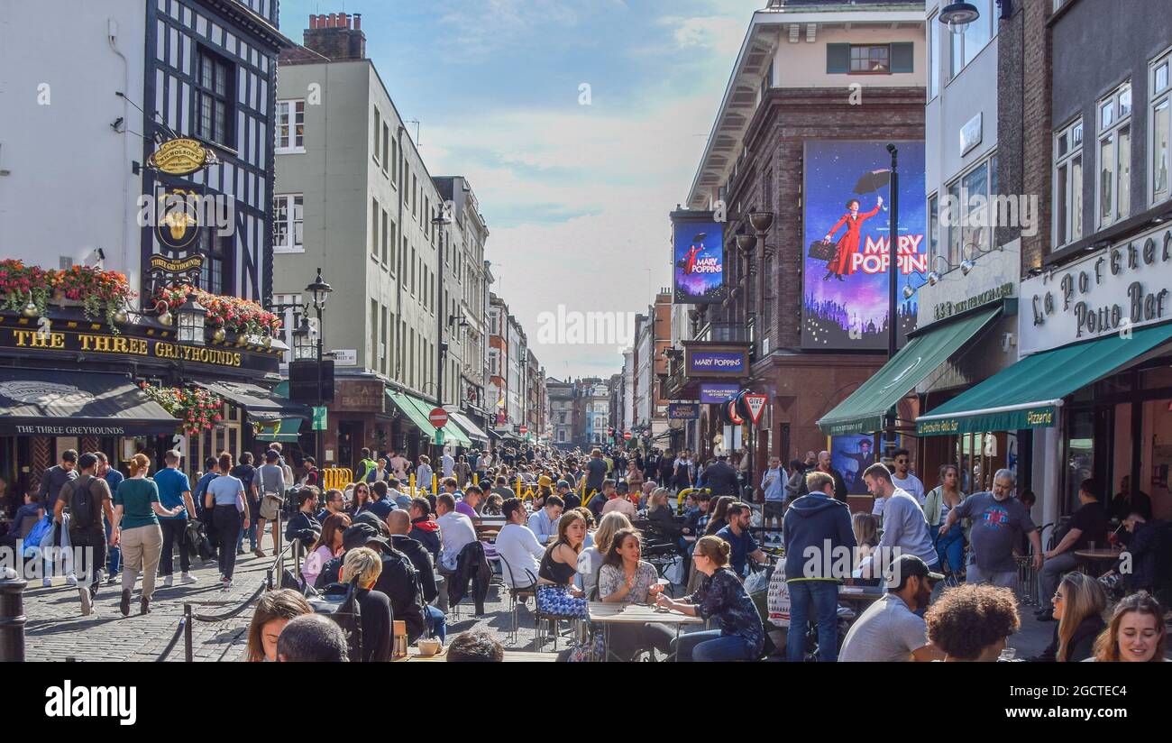 Busy alfresco street seating at restaurants and cafes in Old Compton Street, Soho. London, United Kingdom. 7th August 2021. Stock Photo