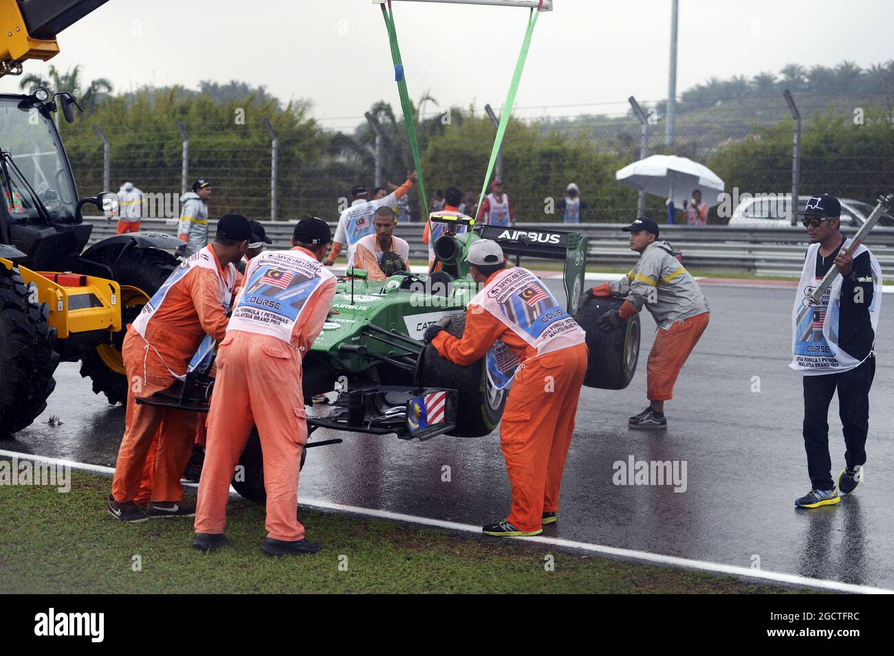 The Caterham CT05 of Marcus Ericsson (SWE) Caterham is recovered by marshalls after he crashed in qualifying. Malaysian Grand Prix, Saturday 29th March 2014. Sepang, Kuala Lumpur, Malaysia. Stock Photo