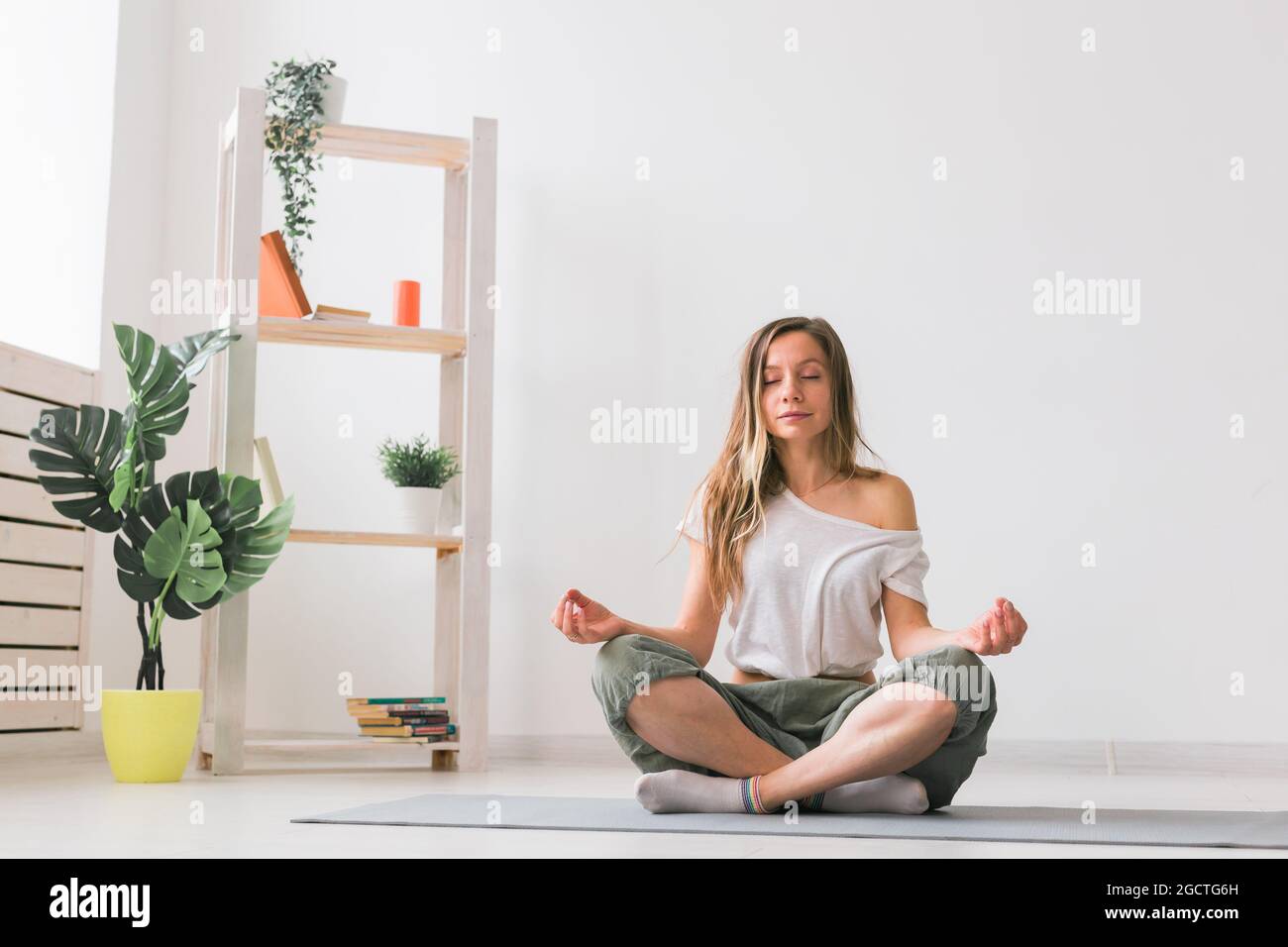 Young woman in the lotus position while meditating. Mindfulness ...