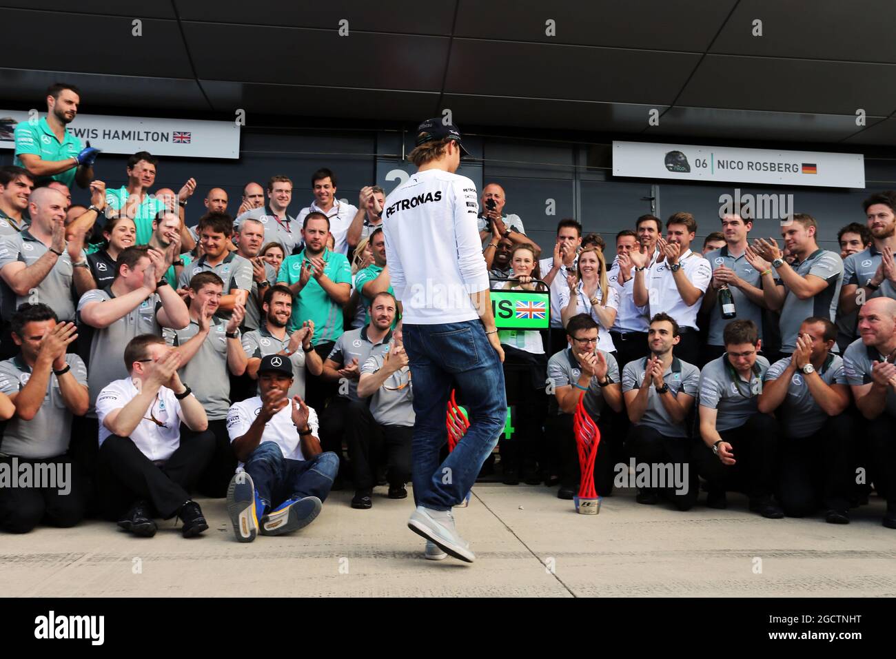 Nico Rosberg (GER) Mercedes AMG F1 comes to celebrate victory for team mate Lewis Hamilton (GBR) Mercedes AMG F1 with the team. British Grand Prix, Sunday 6th July 2014. Silverstone, England. Stock Photo